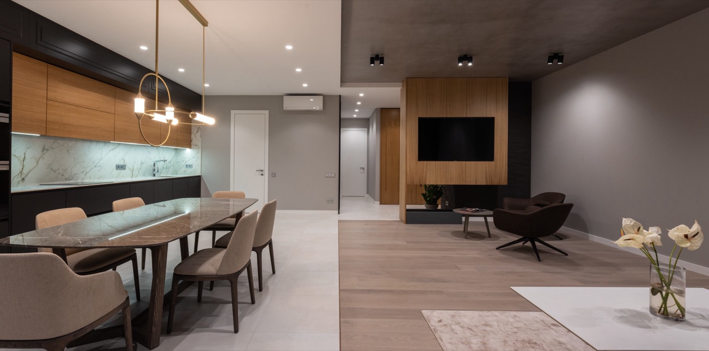 Open-concept dining and living area with warm wood accents